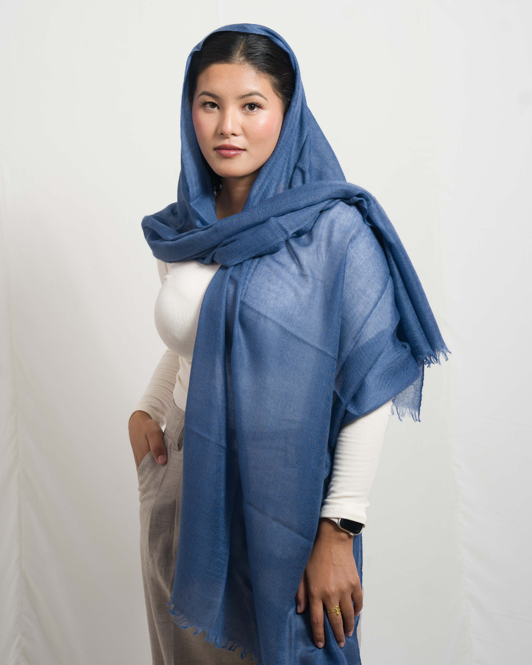 Woman wearing a blue scarf on a white background